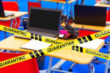 The school is closed for quarantine. An empty computer lab with a background of restrictive tapes labeled Quarantine. Restrictions are related to the coronavirus. Self-limiting mode due to Covid-19.