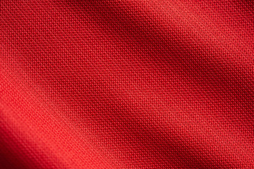 Red sports clothing fabric football jersey texture close up - obrazy, fototapety, plakaty
