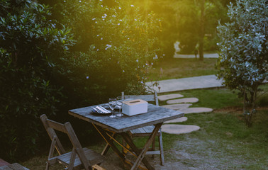 Garden dining table with chairs and equipment for dinner time at garden