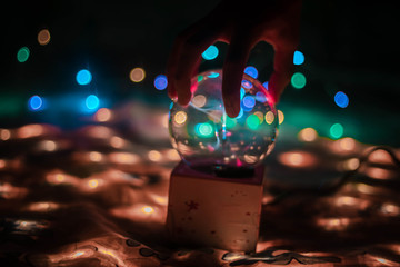 Plasma ball with smooth magenta-blue flames.Plasma ball over fairy light bokeh.Plasma ball