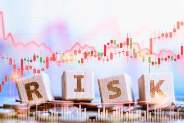 Wood block word RISK on coins stack. Financial risk concept. Money management, interest rates. Economic crisis. Money saving and Investment.