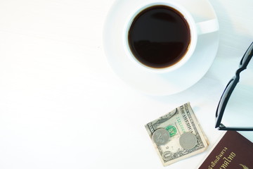 Coffee and money on a white table. The concept of travel.