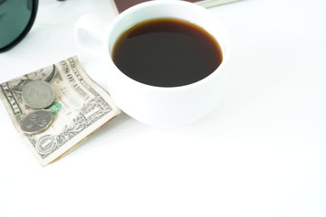 Coffee and money on a white table. The concept of travel.