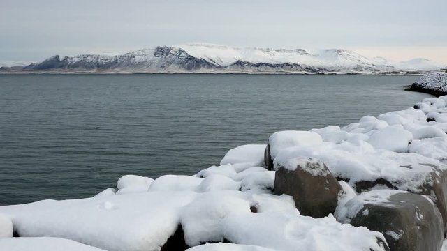 Long shot of Reykjavik snowy Esja mountain