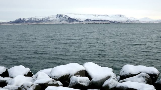 Long shot of Reykjavik snowy Esja mountain