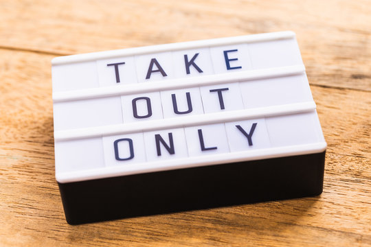 A Sign On A Restaurant Table That Says Take Out Only