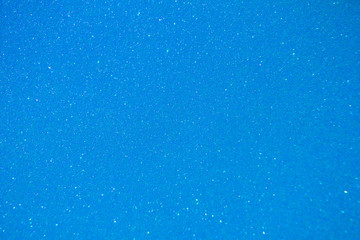 Sparkling sky blue glitter texture background with defocused bokeh