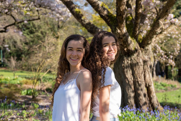 Fototapeta premium Twin teenage sisters laughing and doing outdoors life in Vancouver.