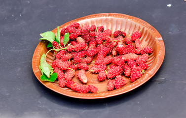 Black ripe and red unripe mulberries on copper metal plate ,.fresh mulberry provides fiber and nutrients highly beneficial. selective focus