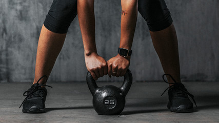 Fit woman using a kettlebell