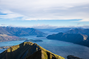 Roys peak mountain hike in Wanaka New Zealand. Popular tourism travel destination. Concept for hiking travel and adventure. New Zealand landscape background.	