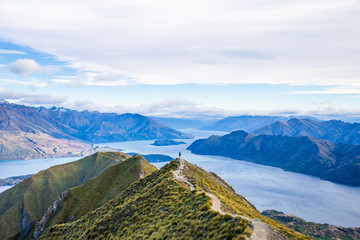 Roys peak mountain hike in Wanaka New Zealand. Popular tourism travel destination. Concept for hiking travel and adventure. New Zealand landscape background.	