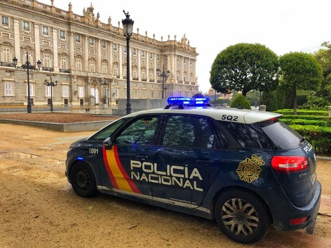 COVID-19 Spain lockdown. Image of A Police car in empty square at the Royal Palace of Madrid center