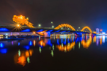 Dragon Bridge in the evening as it is illuminated with colourful LED lights, Han river in Da Nang, Vietnam.