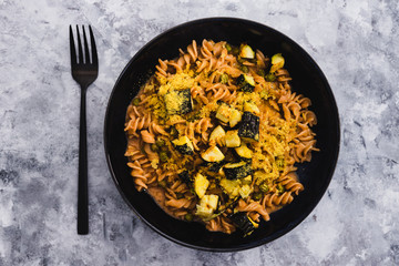 plant-based food, vegan red lentil fusilli pasta with zucchini and nutritional yeast