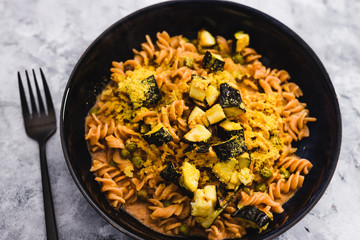 plant-based food, vegan red lentil fusilli pasta with zucchini and nutritional yeast