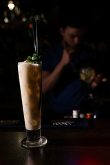 bartender made a creamy alcohol cocktail with mint leaves