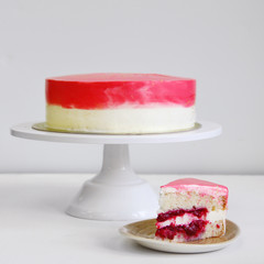 cherry light colored cake on white table close up. dessert concept sliced cake