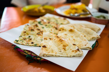 Naan, an oven-baked flatbread found in the cuisines mainly of Western Asia, South Asia, Myanmar and the Caribbean.
