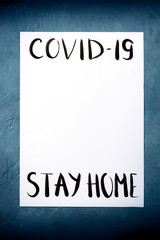Fototapeta premium Covid-19 design template with the Stay at home message in handwriting and place for data