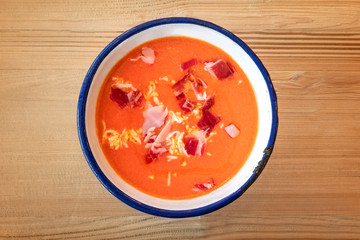Salmorejo, Spanish cold tomato soup, shot from the top on a wooden background