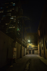 Dark and eerie urban city alley at night 