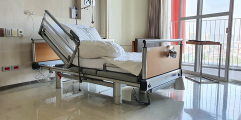 Automatic leveling bed without any patients sleeping The head of the bed was lifted for the patient to use. Located in the hospital room of  patient. Patient's bed with  alcohol gel hanging end of bed