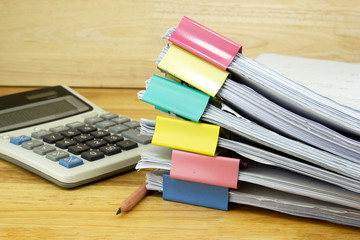 file folder and Stack of business report paper file with 
Calculator on the table in a work office,...