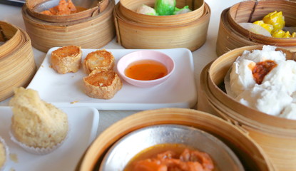 Closeup deep fried crab meat roll cake (Hoi Jo) in white plate with sweet sauce in dim sum set, crab meat in tofu wrap, Chinese restaurant food style