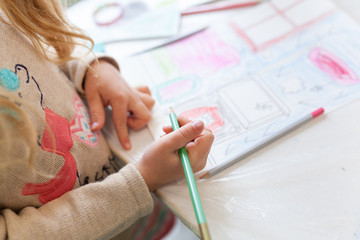 Obraz na płótnie Canvas a child is engaged in creativity, a preschooler makes crafts, Children's creativity at home and in kindergarten.