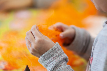 a child is engaged in creativity, a preschooler makes crafts, Children's creativity at home and in kindergarten. Children's hands make from sisal