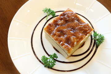 Toffee cake in white plate on wooden table look delicious