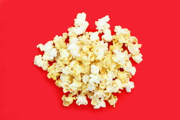 Top view of many salted popcorn mix with cheese popcorn pile on red table background