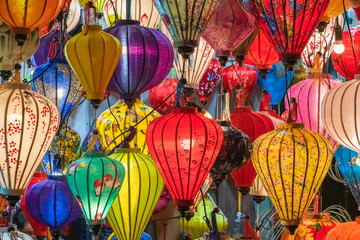 Fototapeta na wymiar Colorful lanterns spread light on the old street of Hoi An Ancient Town - UNESCO World Heritage Site. Vietnam.