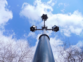 Street lights blue sky background with white clouds, in the form of a cross