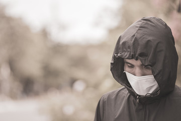 Asian man use surgical mask or face mask to protect corona virus 2019 or covid 19 in public