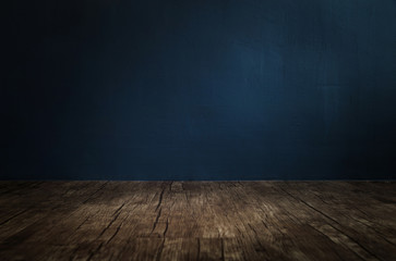 wooden floor with dark blue cement wall