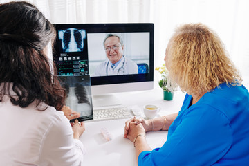 General practitioner and senior patient having telemedicine session with pulmonologist