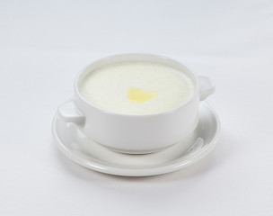 semolina porridge with butter on a white background