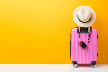 Pink baggage on yellow background, travel concept