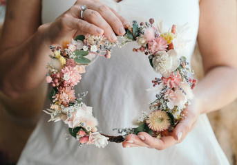 Woman holding flower wreath © rawpixel.com