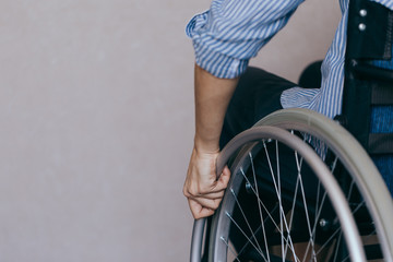 Unrecognizable disabled woman in wheelchair at home. Recovery and healthcare concepts.