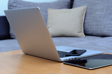 View on a laptop pc and a smartphone and a tablet on a desk in a home office