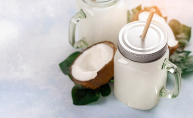 Coconut milk drink or non alcoholic cocktail in glass jar with handle copy space
