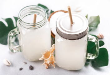 Coconut water drink in glass jar with handle