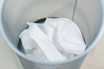Used face masks in medical waste bin. .Prevention the spread of corona virus, COVID-19.