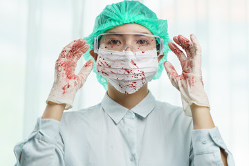 Blood Spilled on doctor's safety glasses, gloves and protective mask.