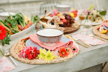 A table set with food and beautiful styling awaiting guests to arrive