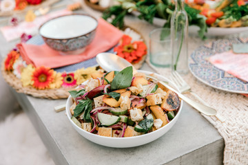 A close up of a summer salad made with ripe vegetables and fruit