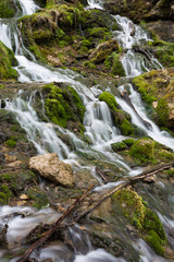 Fototapeta na wymiar City Cesis, Latvia. Old waterfall with green moss and dolomite rocks.